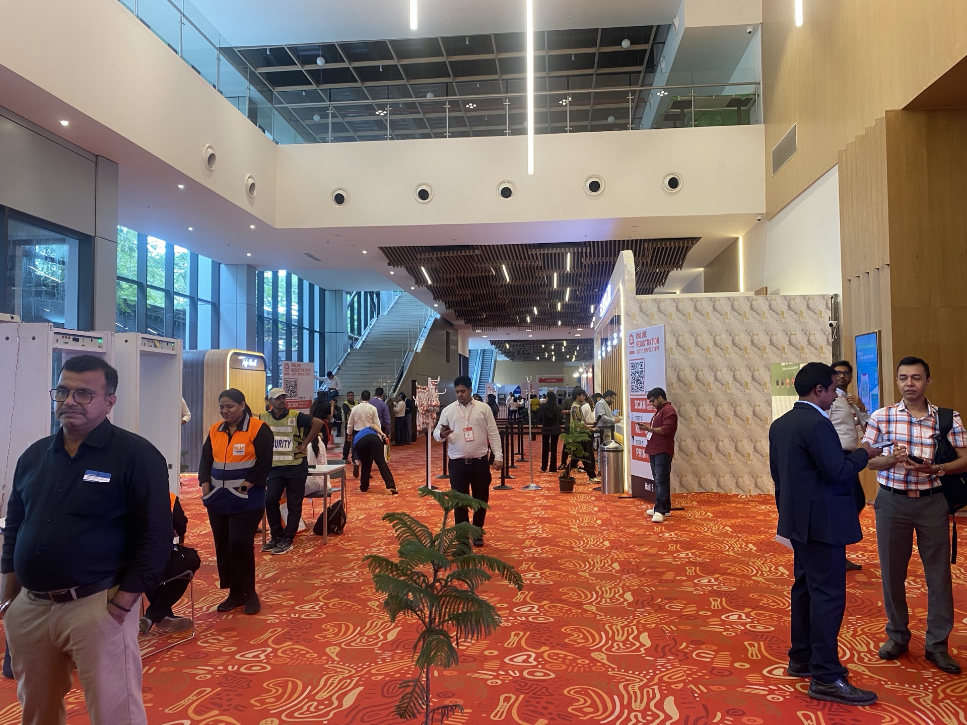 Rich terracotta and red swirl-pattern printed carpet covering the entrance lobby at Anuga Select